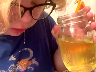 trans boy pisses in a cup and spits it out
