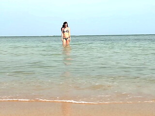 Slender beauty walks along the beach and swims in the sea. meet me