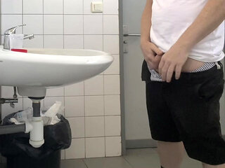 Guy Taking a Urine Sample in Hospital Toilets