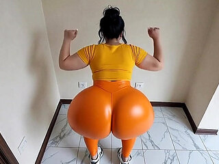big-bootied woman in orange leggings moving