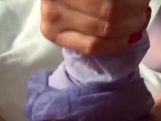 Adeline Murphy does a purple stockings footjob