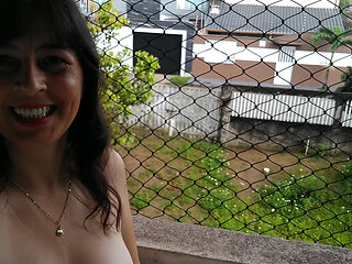 Wife making strip tease on balcony