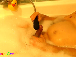 Masturbating in the bathtub with foam, a vibrator on penis makes him produce precum. (S)