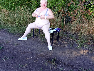 a neighbor in the park undresses and masturbates to orgasm on a bench