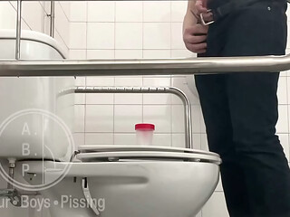 In the Hospital Toilets, a Guy Pisses Into a Cup for a Urine Sample, Then Gets Horny, Jerks-off and Cums