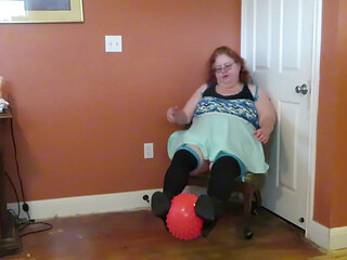 Nurse Vicki  plays with a rubber ball in a mini skirt, sexy stockings and high heel mini boots