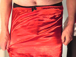 Showing  pink panties with red stockings and red satin slip