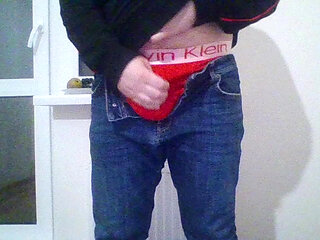Young guy Andrew is jerking his cock by the window while he is alone