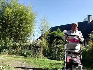 In gardening attire with a layer to mow the lawn.