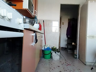Sexy wife having fun in the kitchen with roses.