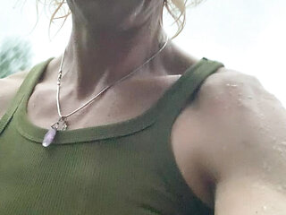 Trans-girl Alexa Cosmic soaking wet in summer rain and getting nude and playing water hose