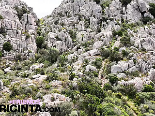Asiab Babe Putri Cinta strips down and takes a daring walk atop a towering peak.