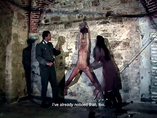 Hanging at the wall with her legs spread wide apart the female prisoner is made hot by lashes (preview)