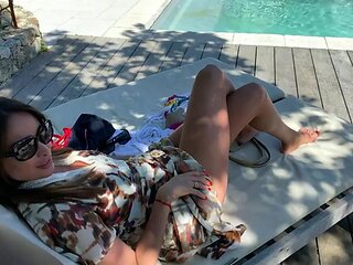Woman watches friend get a BBC poolside