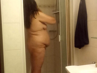 Mature chubby woman in the shower  big belly can be seen well