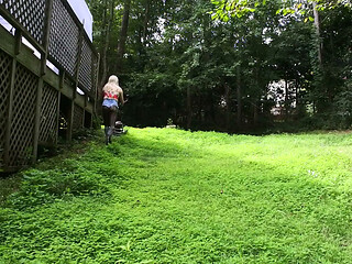 Big Fake Tits Crossdresser in Daisy Dukes Mowing Grass