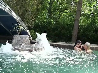 Enamored lesbian couple make out and eat each other's pussies by the pool