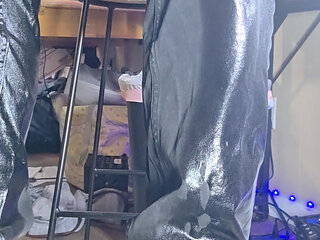 Wetting thick black pants standing in living room.