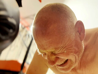 Hot waxing the bald head of the prisoner