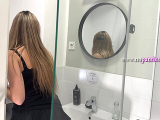 Amazingly beautiful college girl in the bathroom with a super skirt miniskirt shows her ass