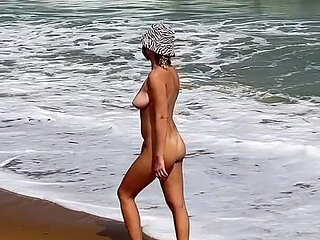 A Busty Blonde Is Walking and Sunbathing Naked