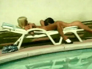 Tempting babes sharing big dildo poolside