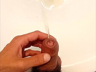 I play with my cock while I pee