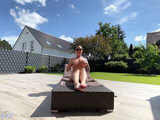 Hot milf pampers her sexy body on the terrace and oils herself