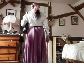 In bourgeoise attire with an old pink pleated skirt for a day