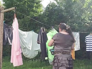 In an outfit with a charcoal colored ruffled dress to gather the laundry.