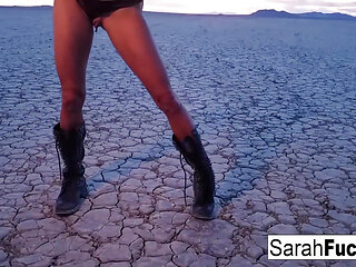 Sexy Tattooed hottie strips on a dry bed lake