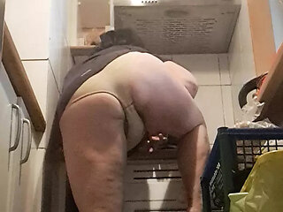 in the kitchen, relaxed, supported on her back