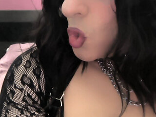 Crossdresser masturbating in high boots and leather gloves