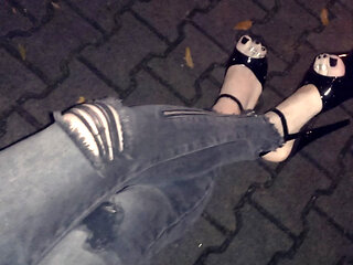a crossdresser in high heels on a night walk