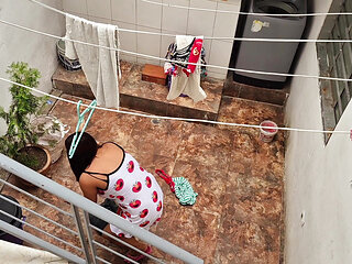The neighbor is watched washing clothes by her neighbor
