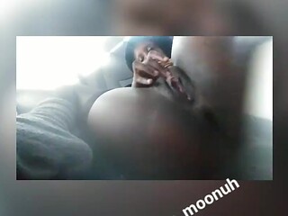 Ebony babe rubs her big juicy clit in the back of a parked Uber car.