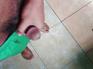 a young man masturbating in a quiet kitchen