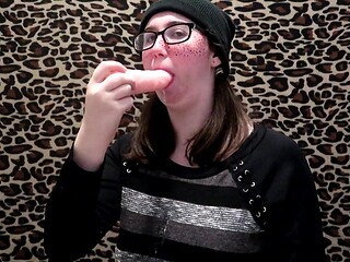 Nerdy girl practices her sloppy blowjob technique using a dildo while