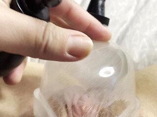 Sultry solo close-up of big clit pumping with a pussy pump