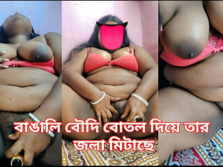 A Bengali woman quenches her thirst with a bottle