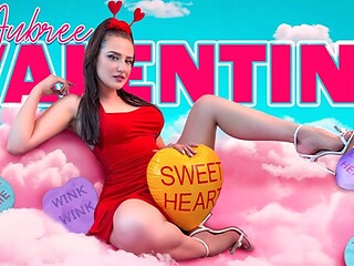Brunette in red dress opens gift box amid heart balloons and Valentine streamers