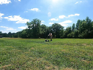 Jon Scarecrow completely naked  in cowboy boots push mowing the grass