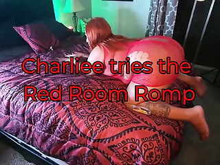 Charliee gets frisky in a red room