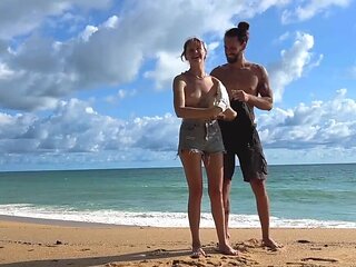 Tattooed hottie and her partner are naked on the beach