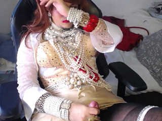Crossdresser relaxing in pearls and heels