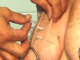 Mature Redhead MILF Endures Needles and Heavy Weights