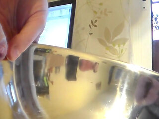 Closeup of John peeing into a steel bowl