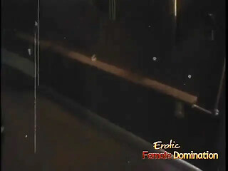 Blonde domatrix punishes masked submissive in an erotic femdom scene