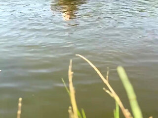Trans girl swimming in the lake in blue sport dress. Wetllok trans girl wet.