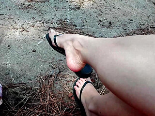 Crazy Dangling in My Leather Black Flip Flops in a Park